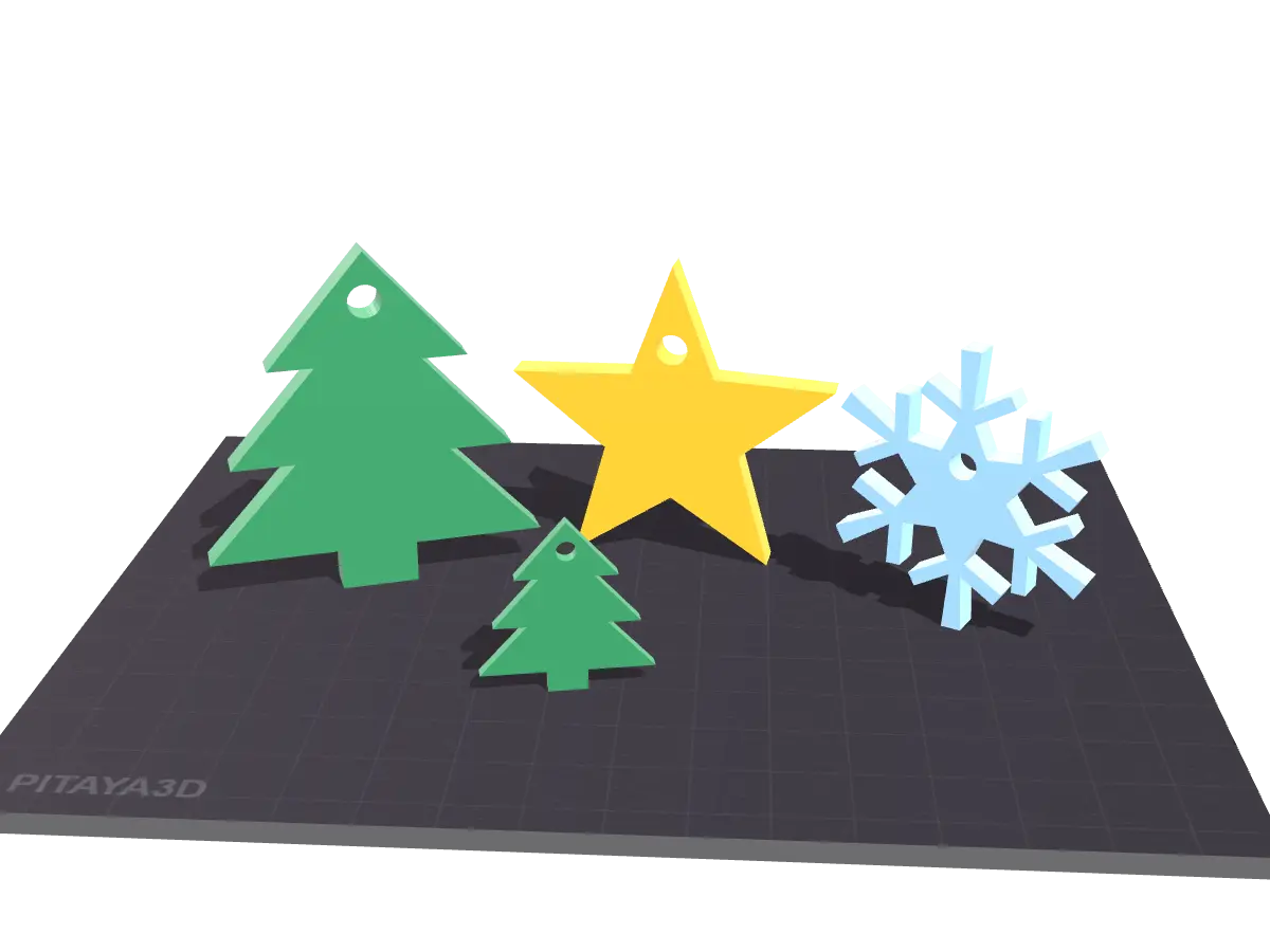Árboles, estrella y copo de nieve impresos en 3D sobre la cama de la impresora